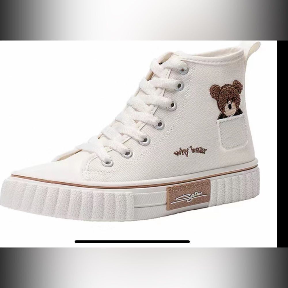 Cute white canvas sneakers with lil Bear peeking out .